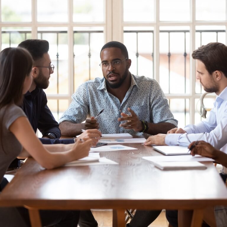 confident Nigerian professional leading a diverse team in a meeting